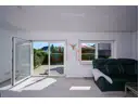 Blick in das helle und großzügige Wohnzimmer mit Zugang zur sonnigen Terrasse