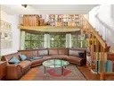 Wohnbereich mit Blick auf Park, über der Lounge-Couch befindet sich die Galerie